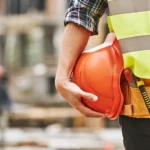 Construction worker holding helmet